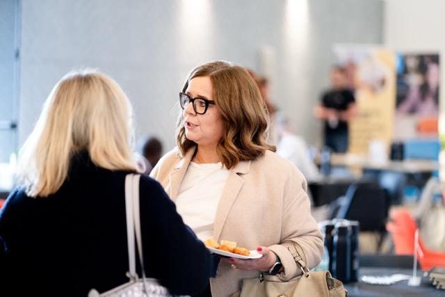 Two founders in close conversation, between sessions