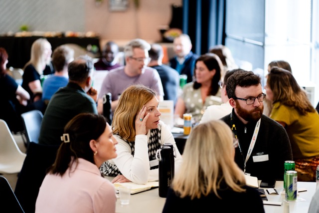 The room — eight tables in conversation
